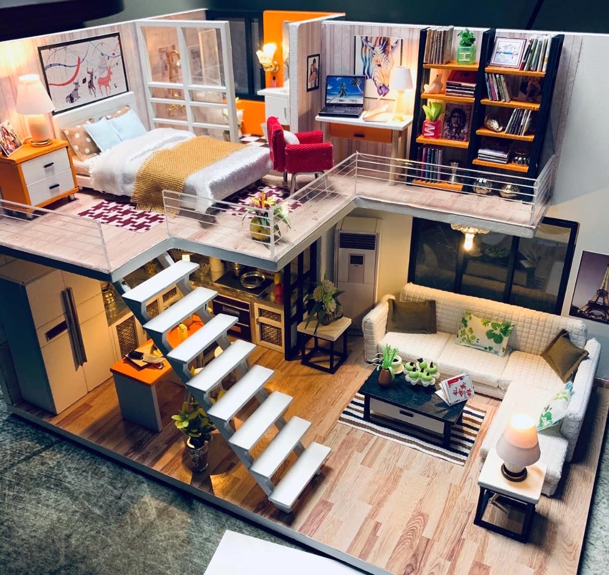 Miniature Atelier hero scene with glowing townhouse windows and layered greenery.